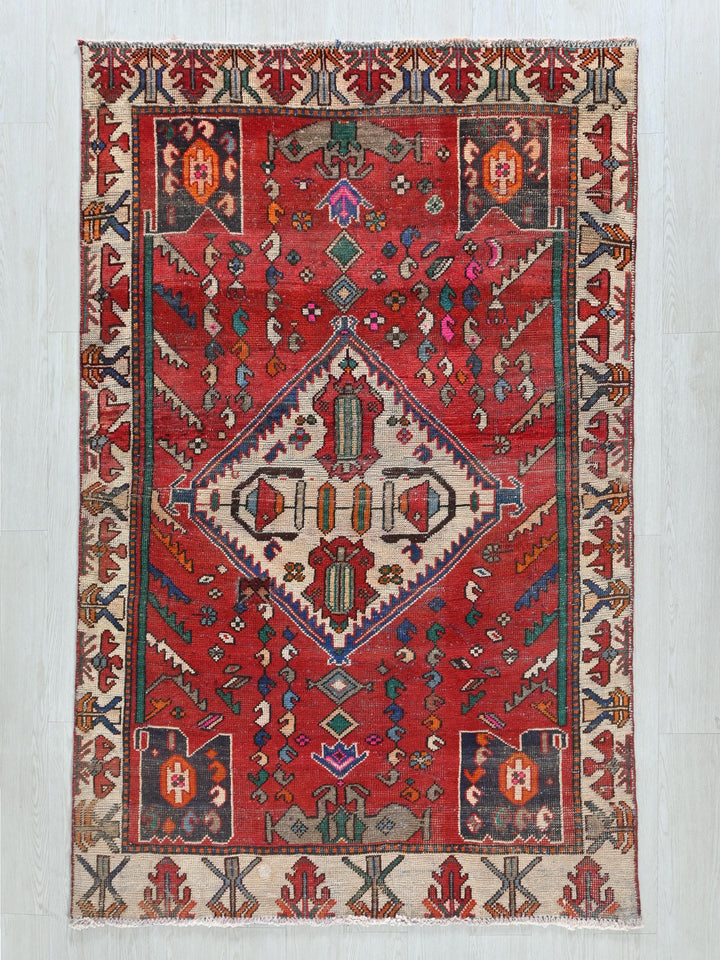 a red rug with a diamond shaped design
