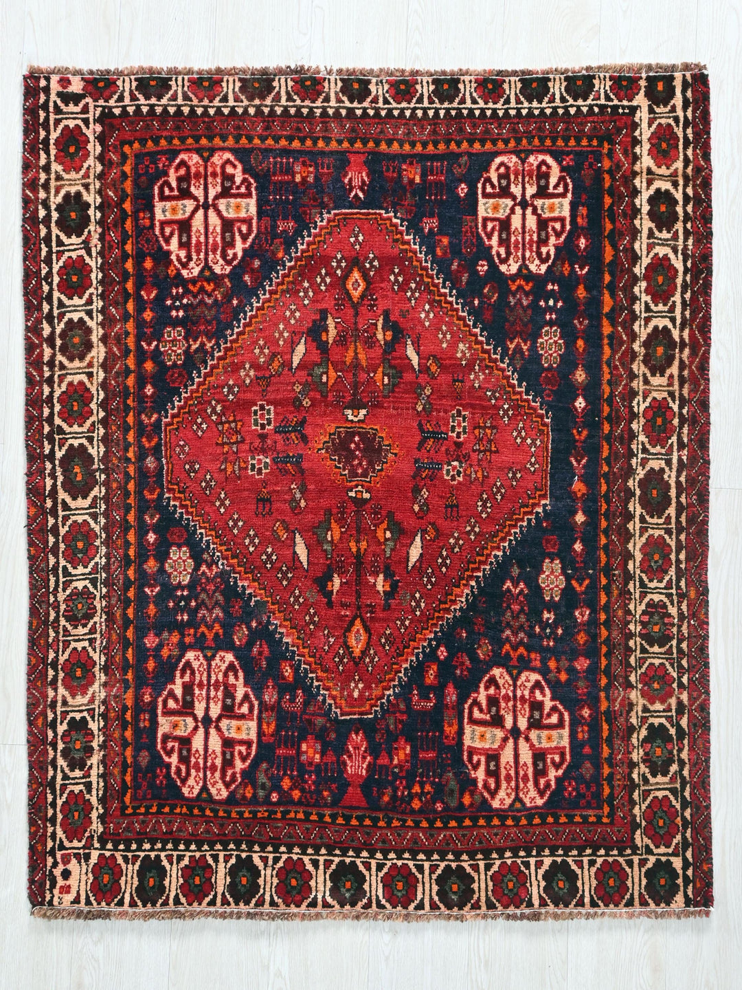 a red and blue rug on a white background