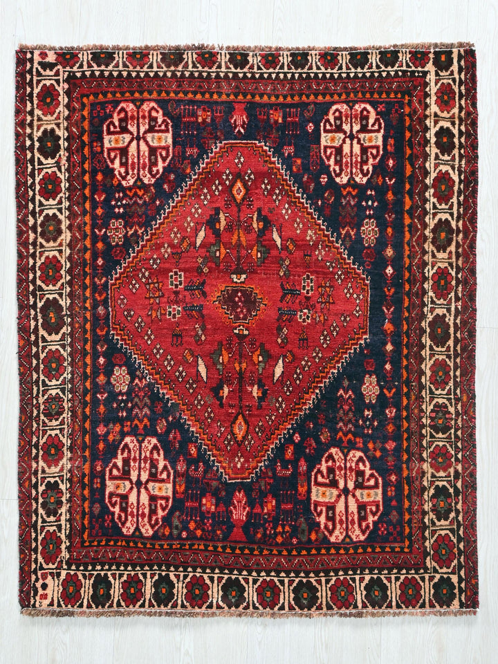 a red and blue rug on a white background