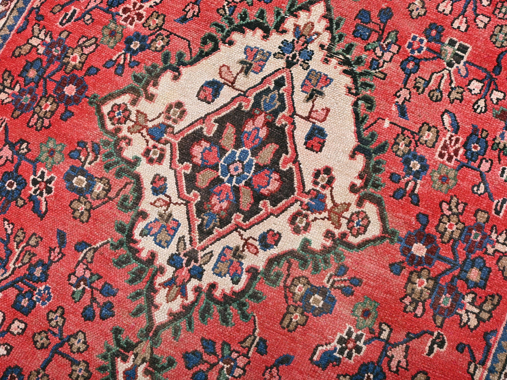 a close up of a red oriental rug