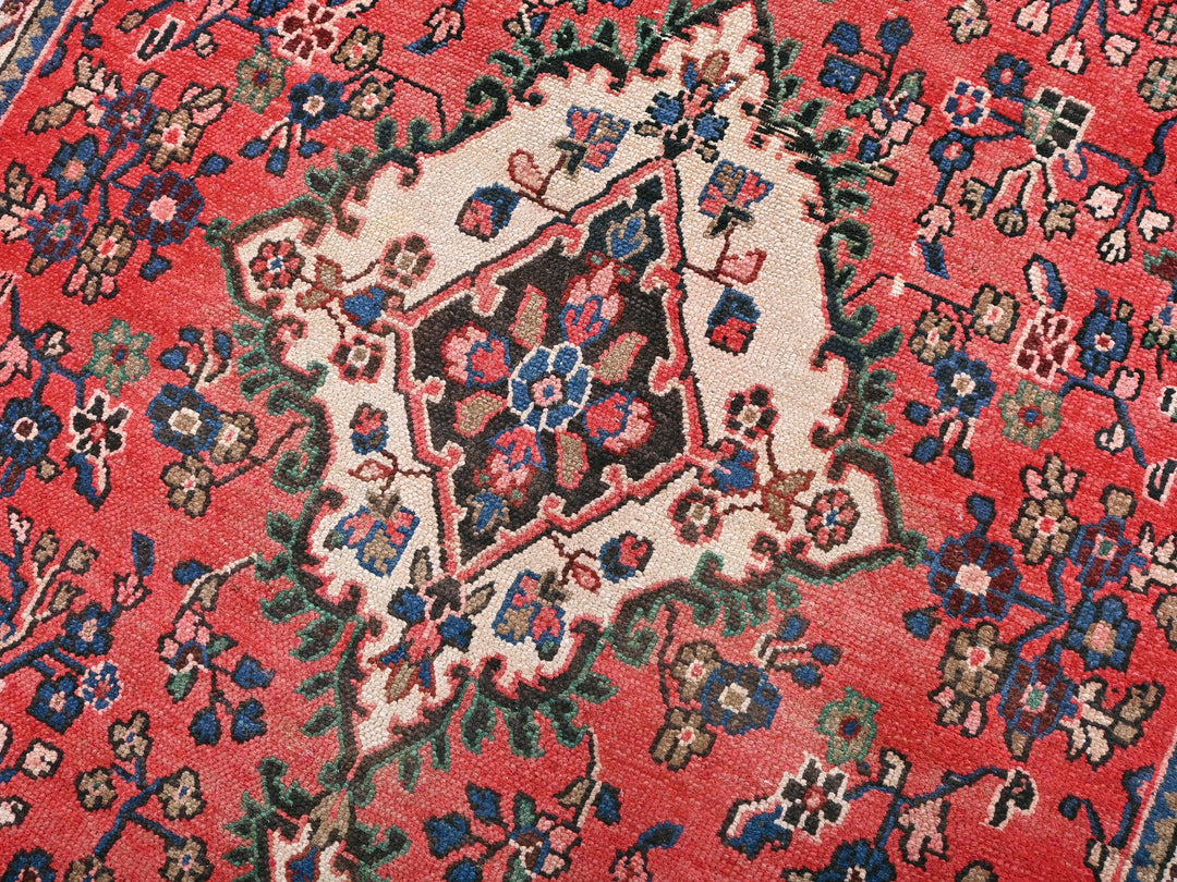 a close up of a red oriental rug