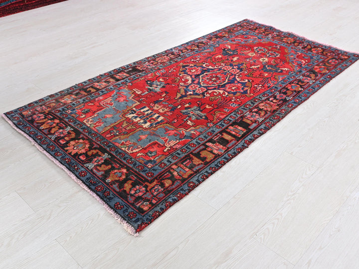 a red and blue rug on a white floor