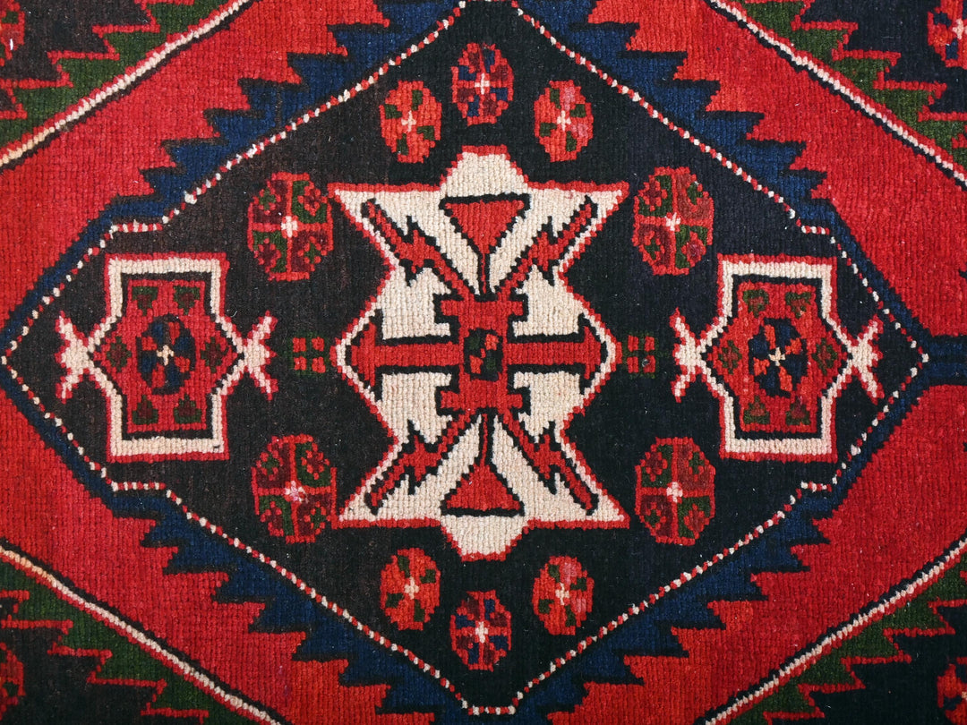 a close up of a red and black rug
