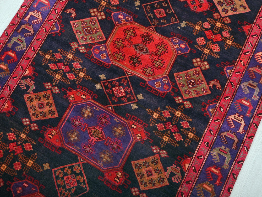 a colorful oriental rug with a red center