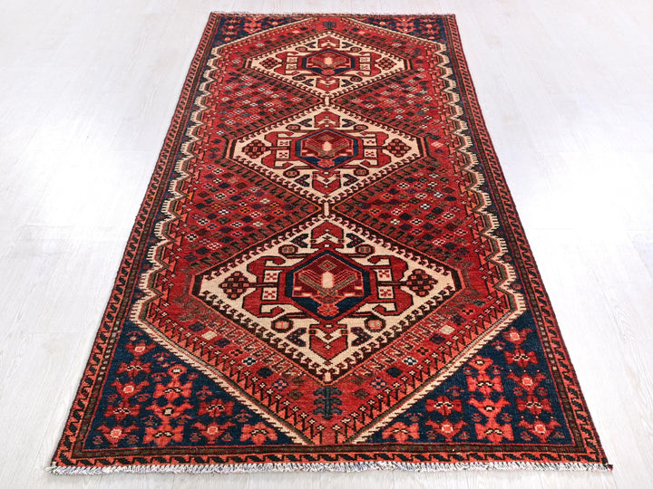 a red and blue rug on a white floor