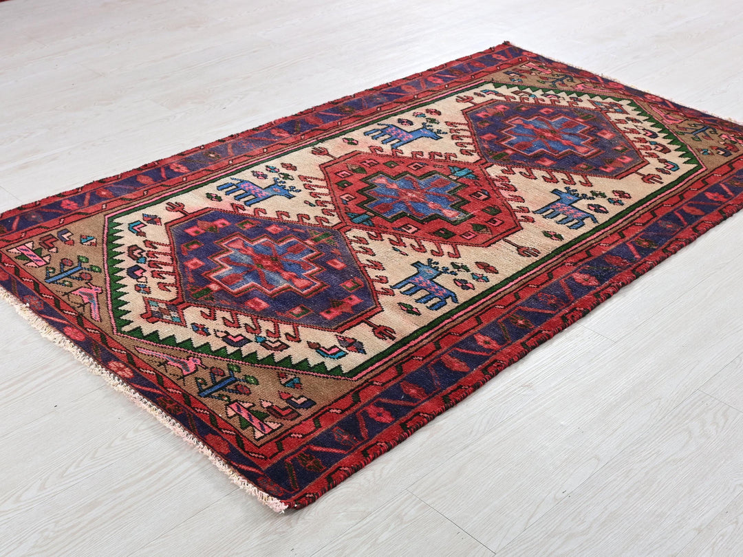 a red and blue rug on a white floor