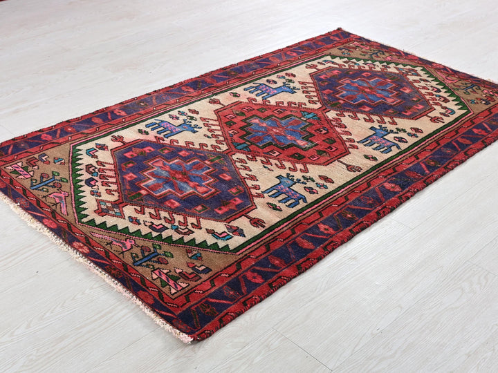 a red and blue rug on a white floor