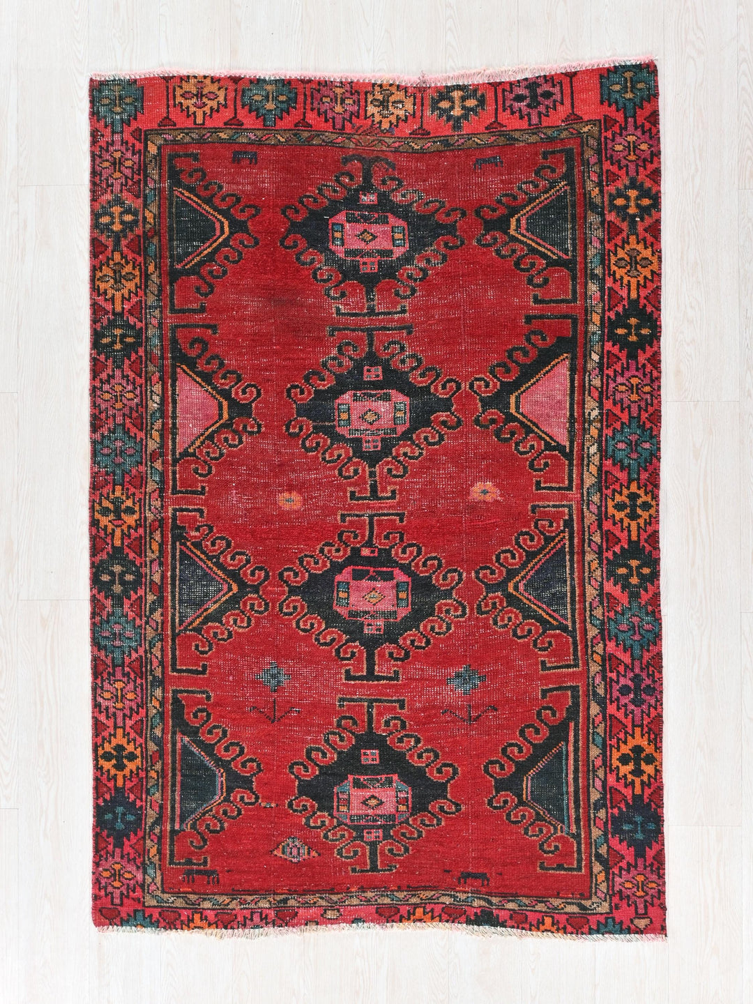 a red rug with a black and red design on it