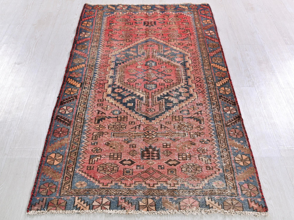 a red rug with a blue and red design on it