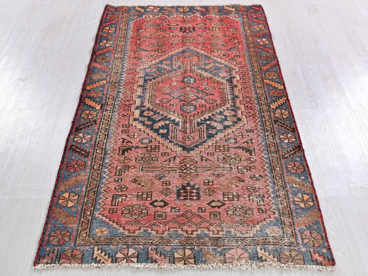 a red rug with a blue and red design on it