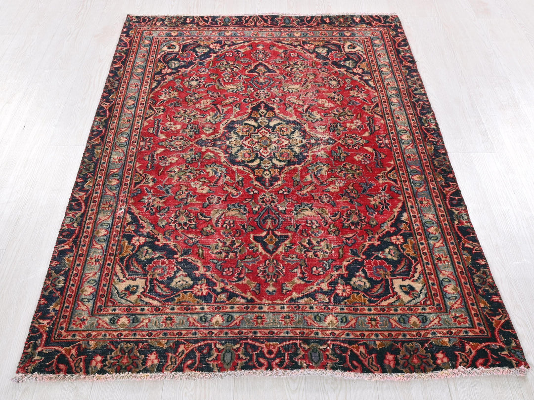 a red and blue rug on a white floor