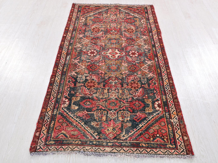 a red and blue rug on a white floor