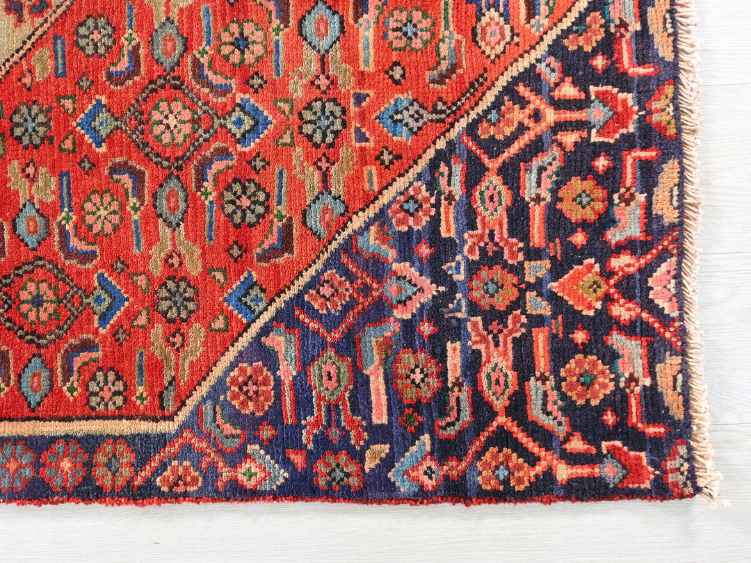 a red and blue rug with a design on it