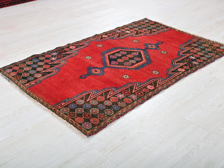 a red rug on the floor of a room