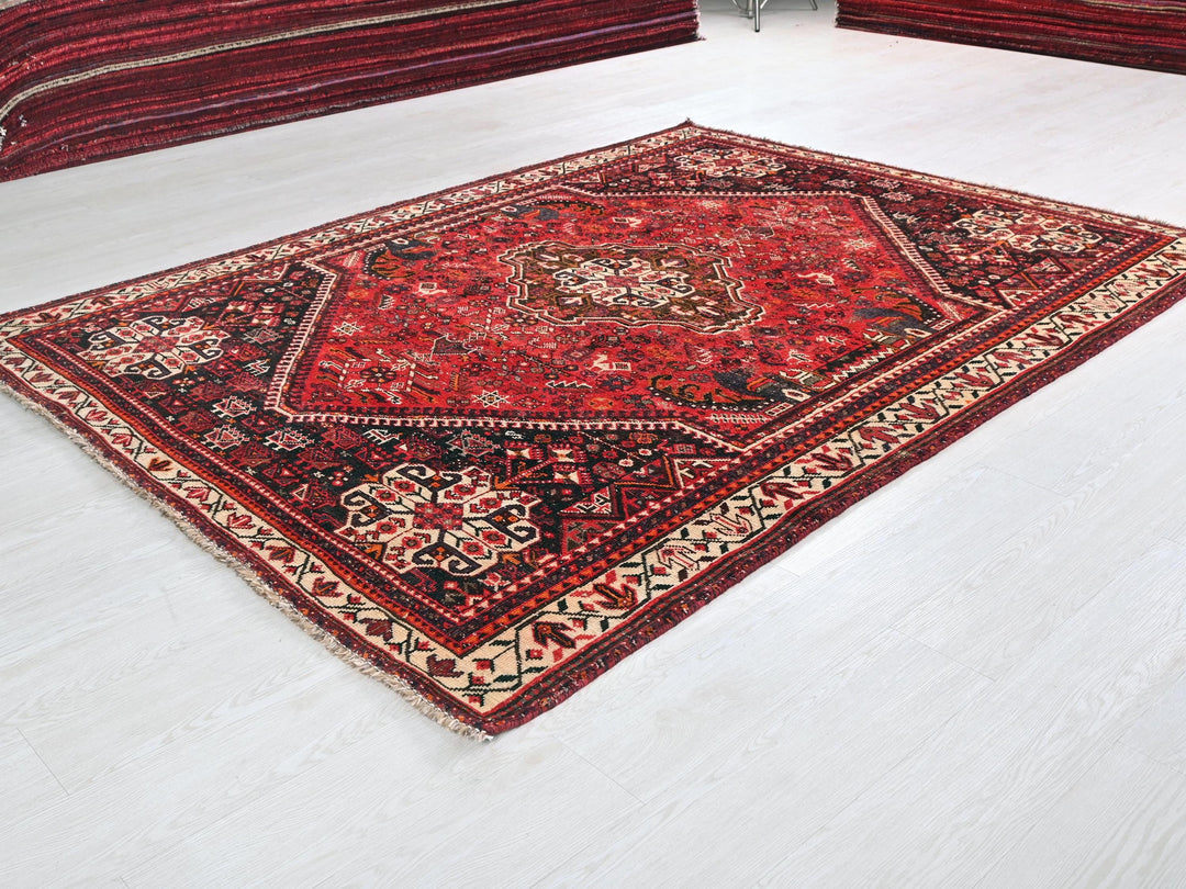 a red rug on the floor of a room