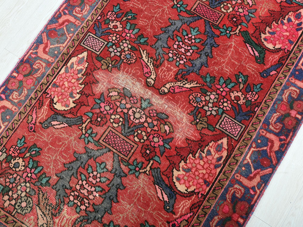 a red rug with a floral design on it