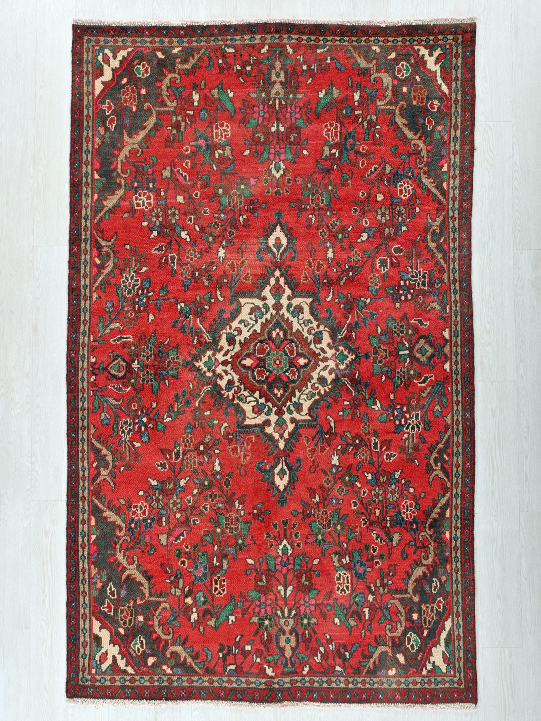 a red rug with an intricate design on it