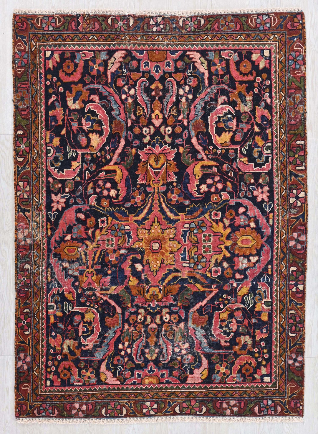 an antique persian rug with a floral design