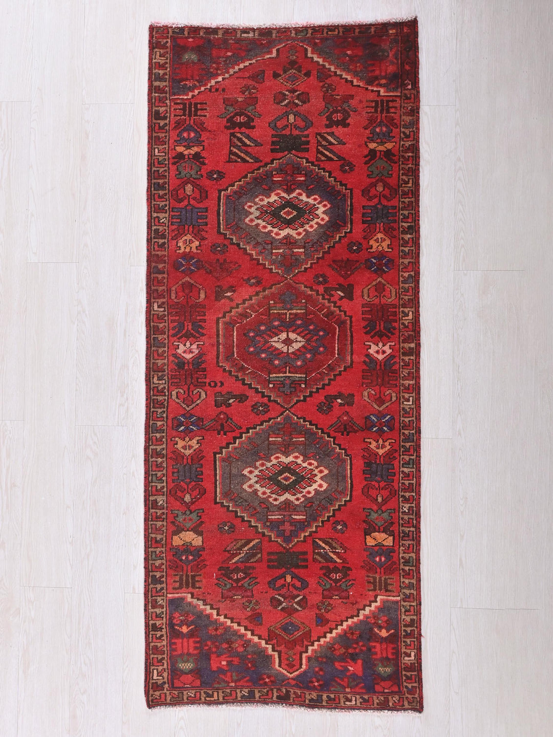 a red rug on a white floor
