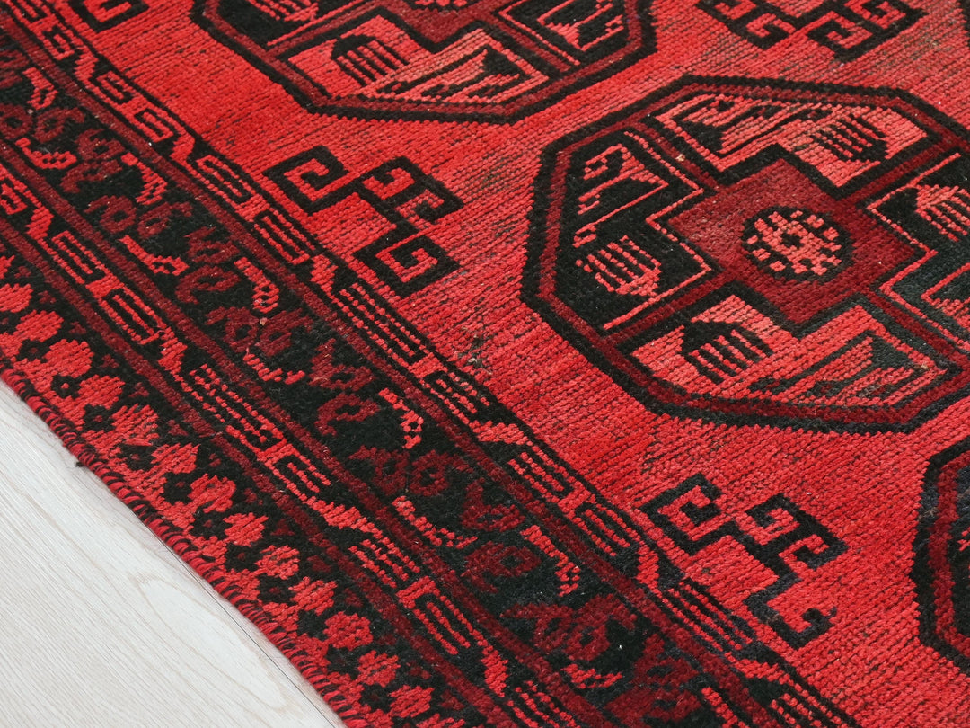 a close up of a red oriental rug