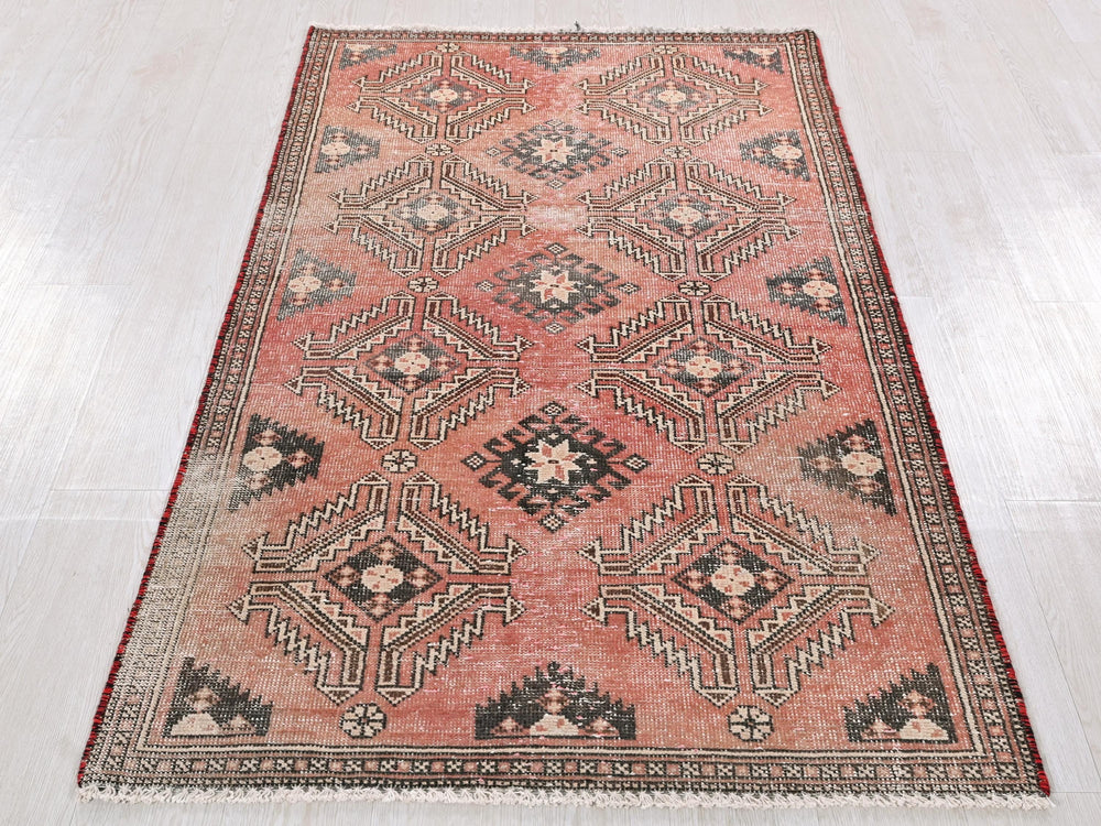 a red rug with a black and white design on it