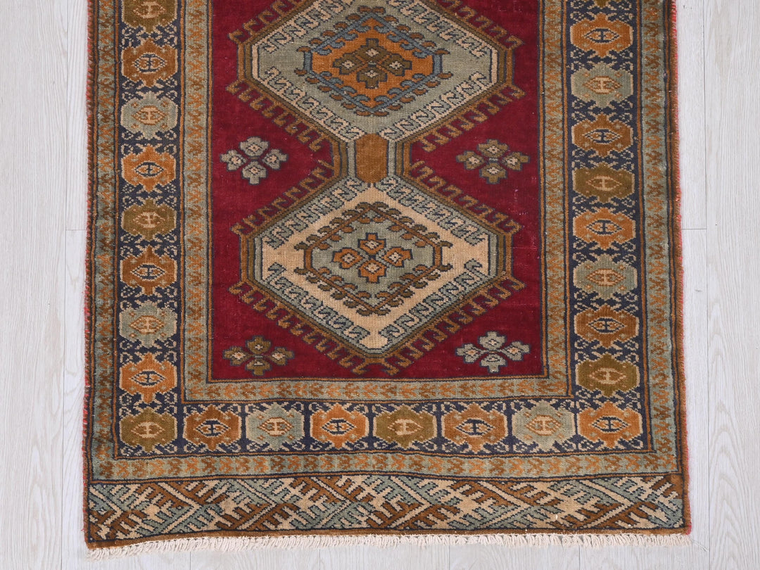 a red rug with a design on it