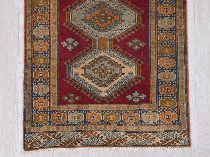 a red rug with a design on it