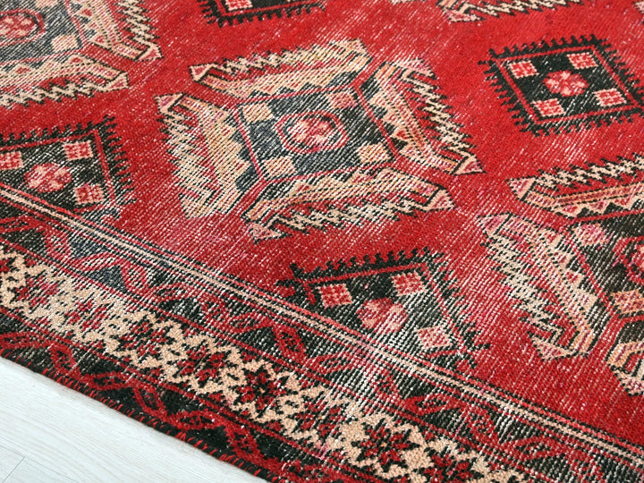 a close up of a red rug on the floor