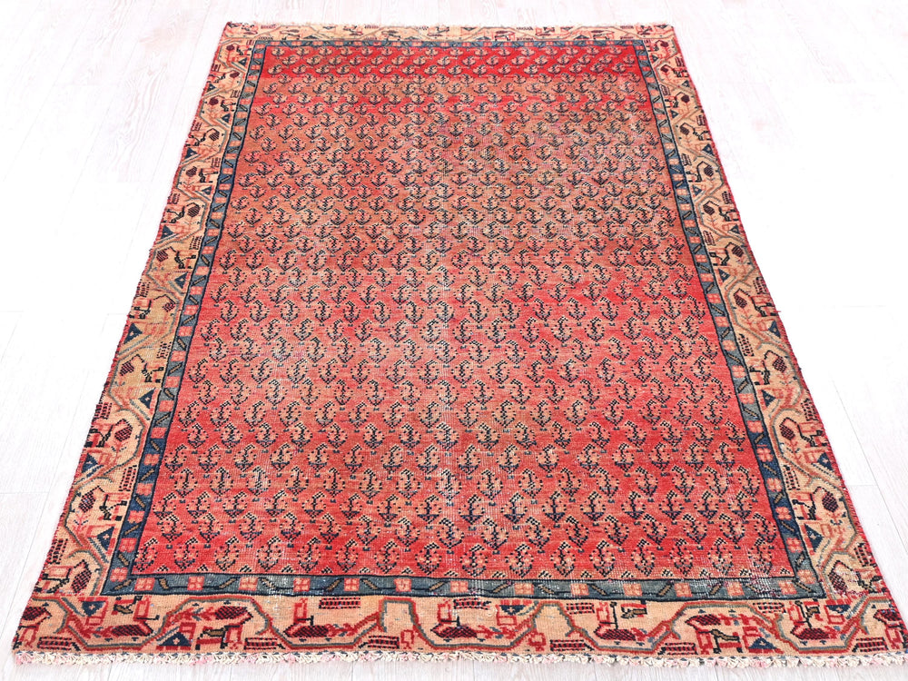 a red and blue rug on a white floor