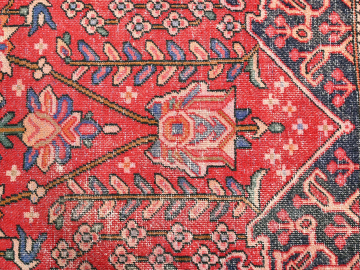 a close up of a red rug with many designs