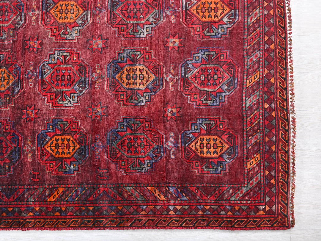 a red rug with a pattern on it