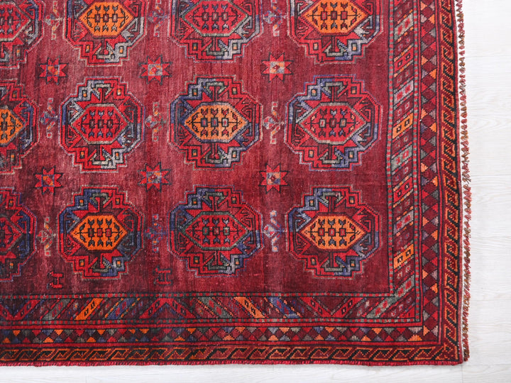a red rug with a pattern on it