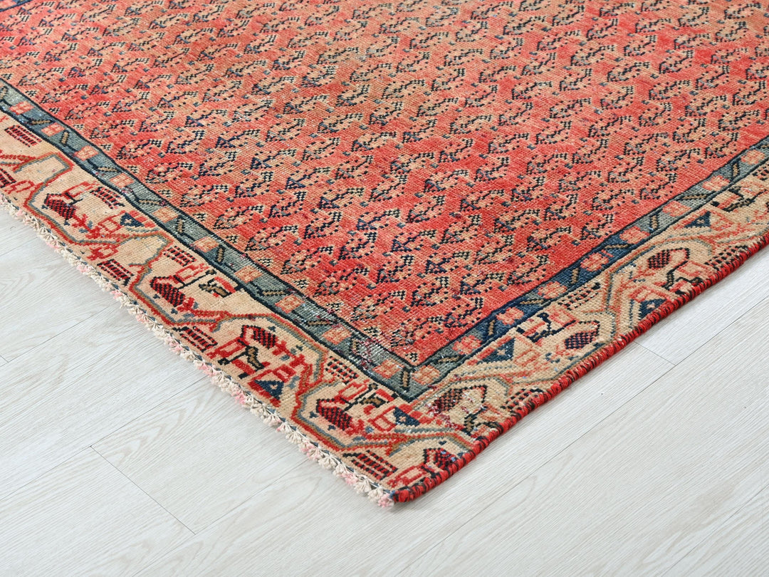 a red and blue rug on a white floor