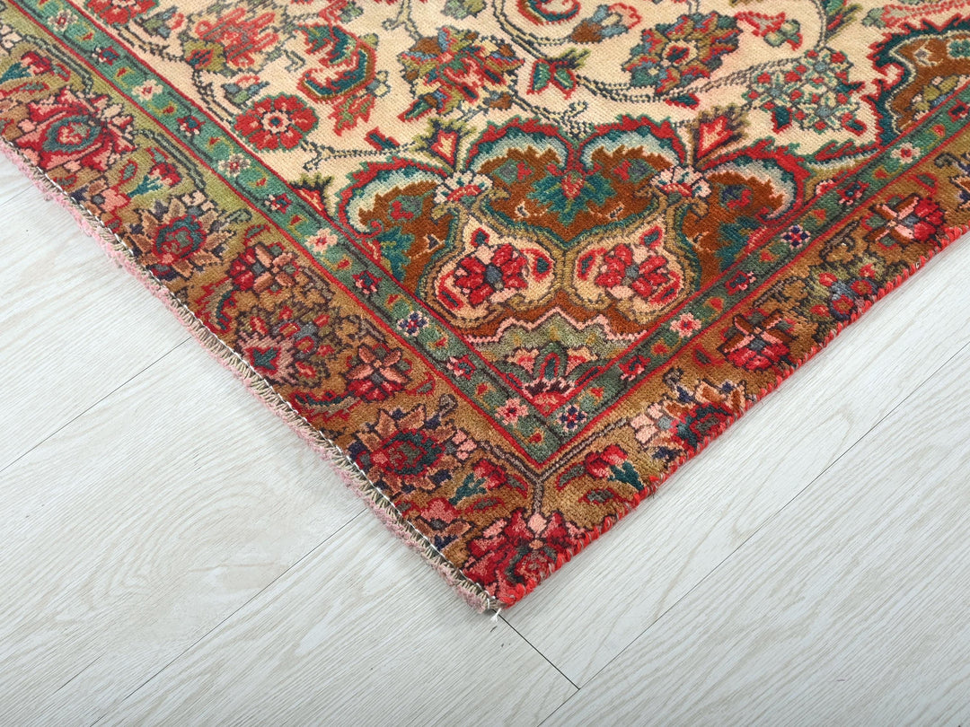 a red and green rug on a white floor