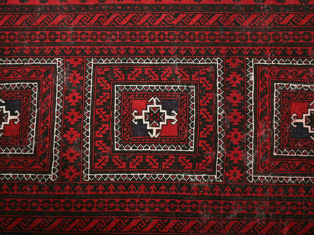a close up of a red and black rug