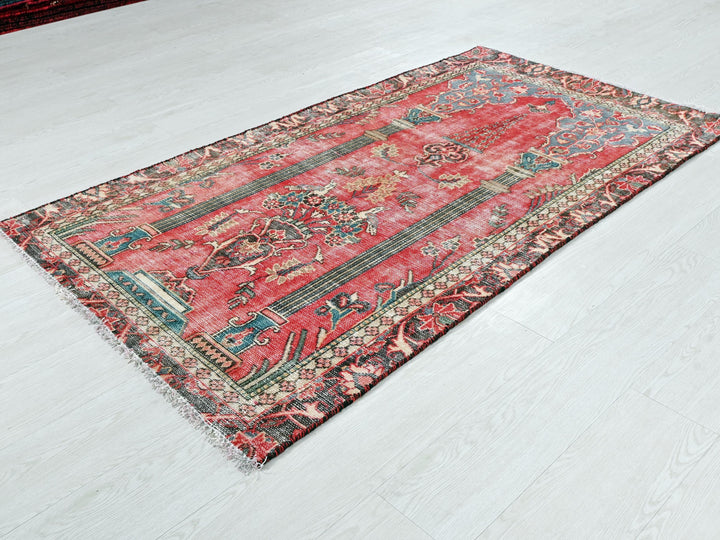 a red oriental rug on a white floor