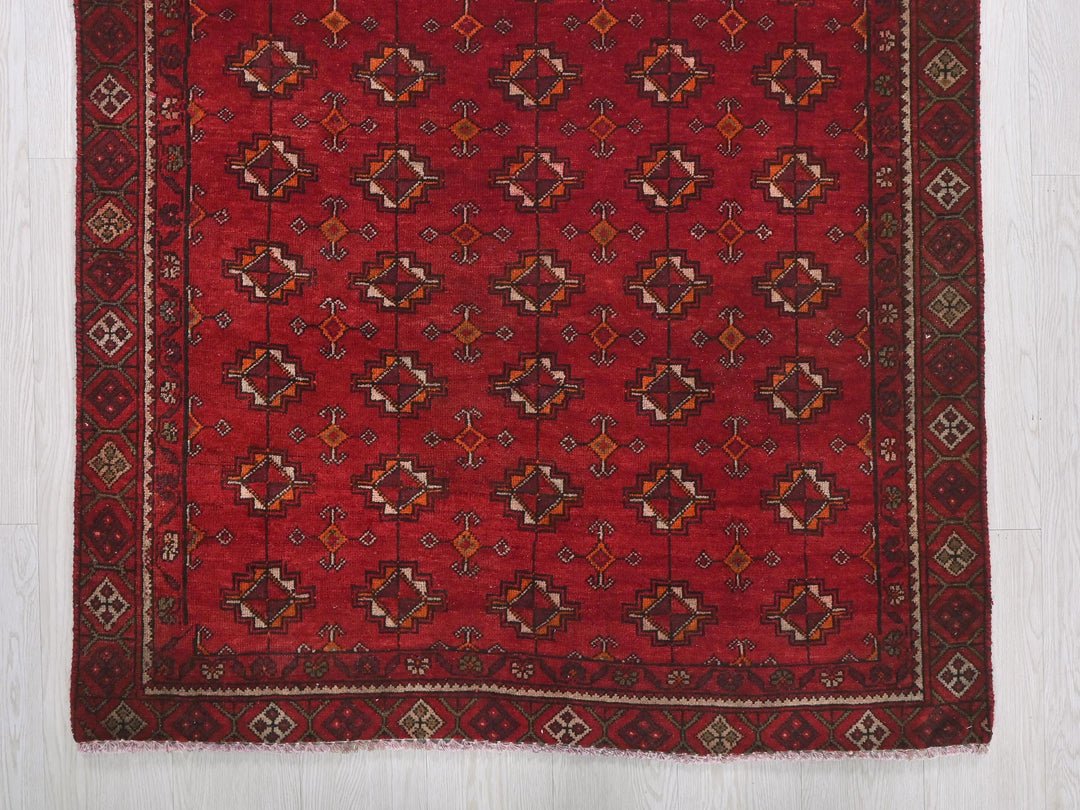 a red rug on a white wooden floor