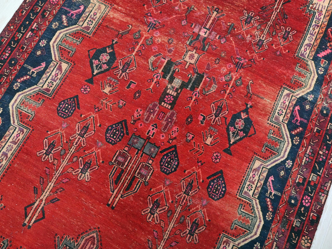 a red oriental rug with a blue border