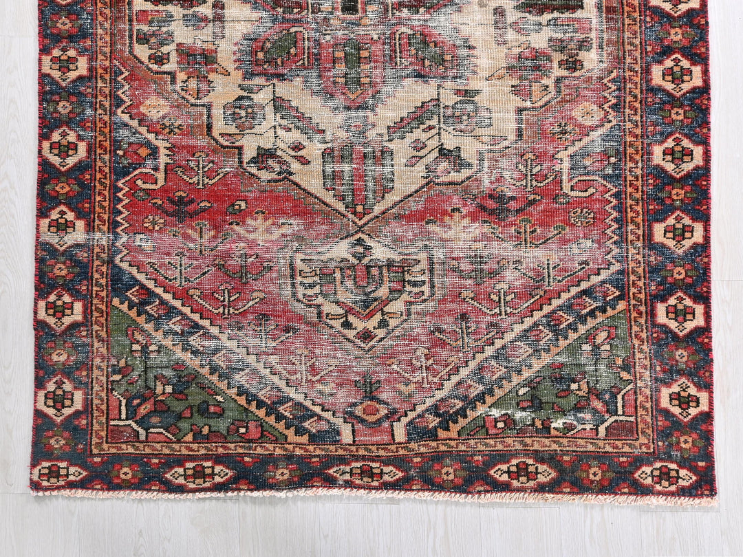 a red and blue rug on a white floor