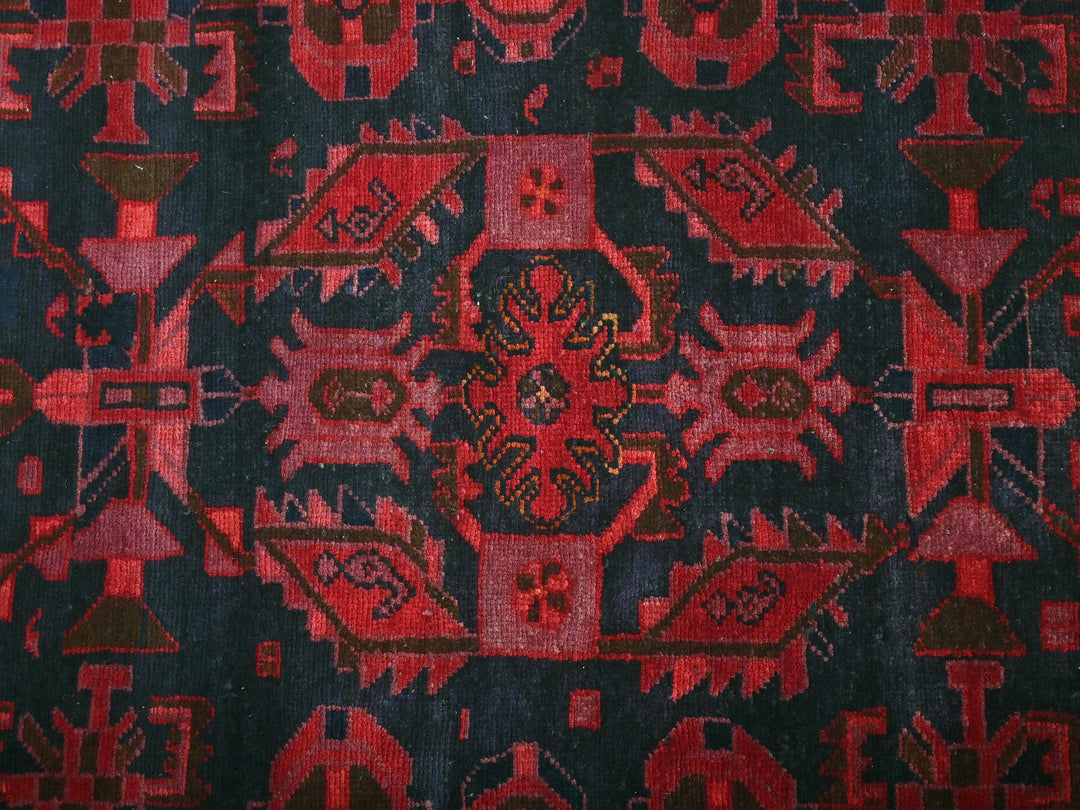 a close up of a red and black rug