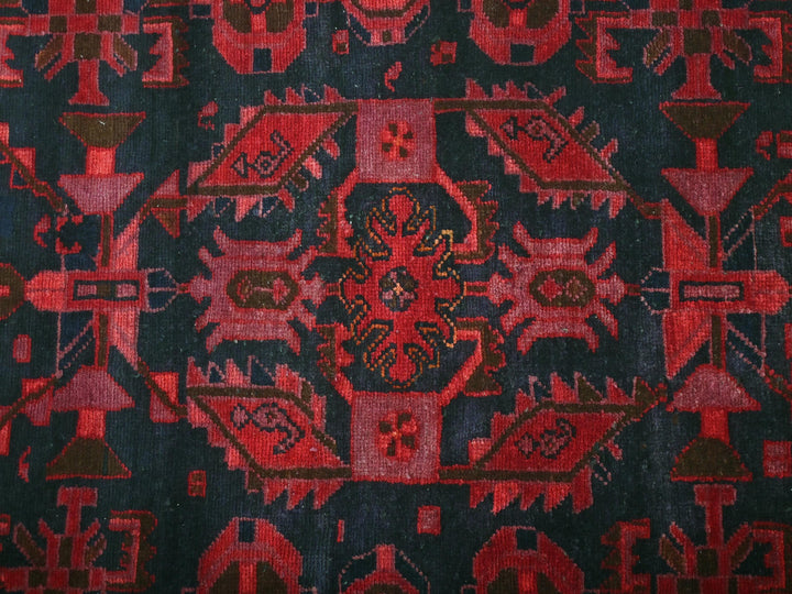 a close up of a red and black rug