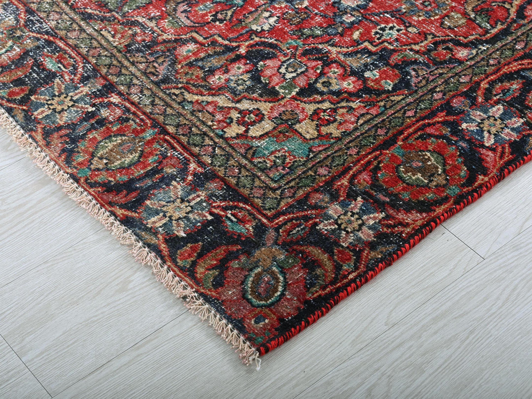 a red and blue rug on a white floor