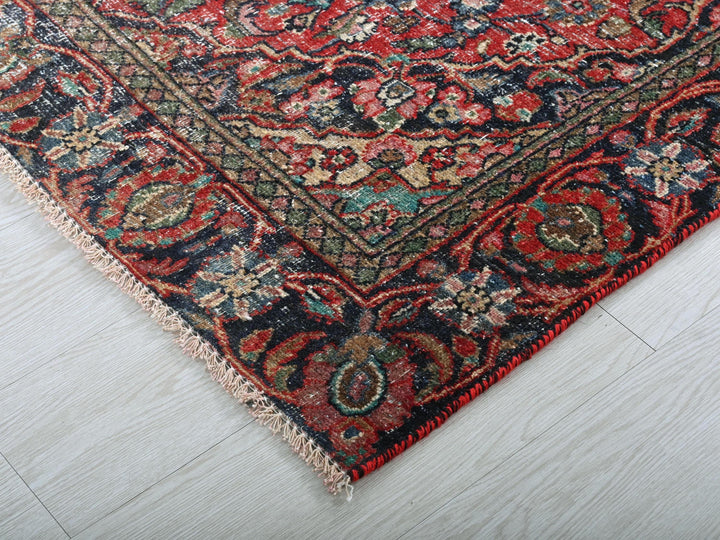 a red and blue rug on a white floor
