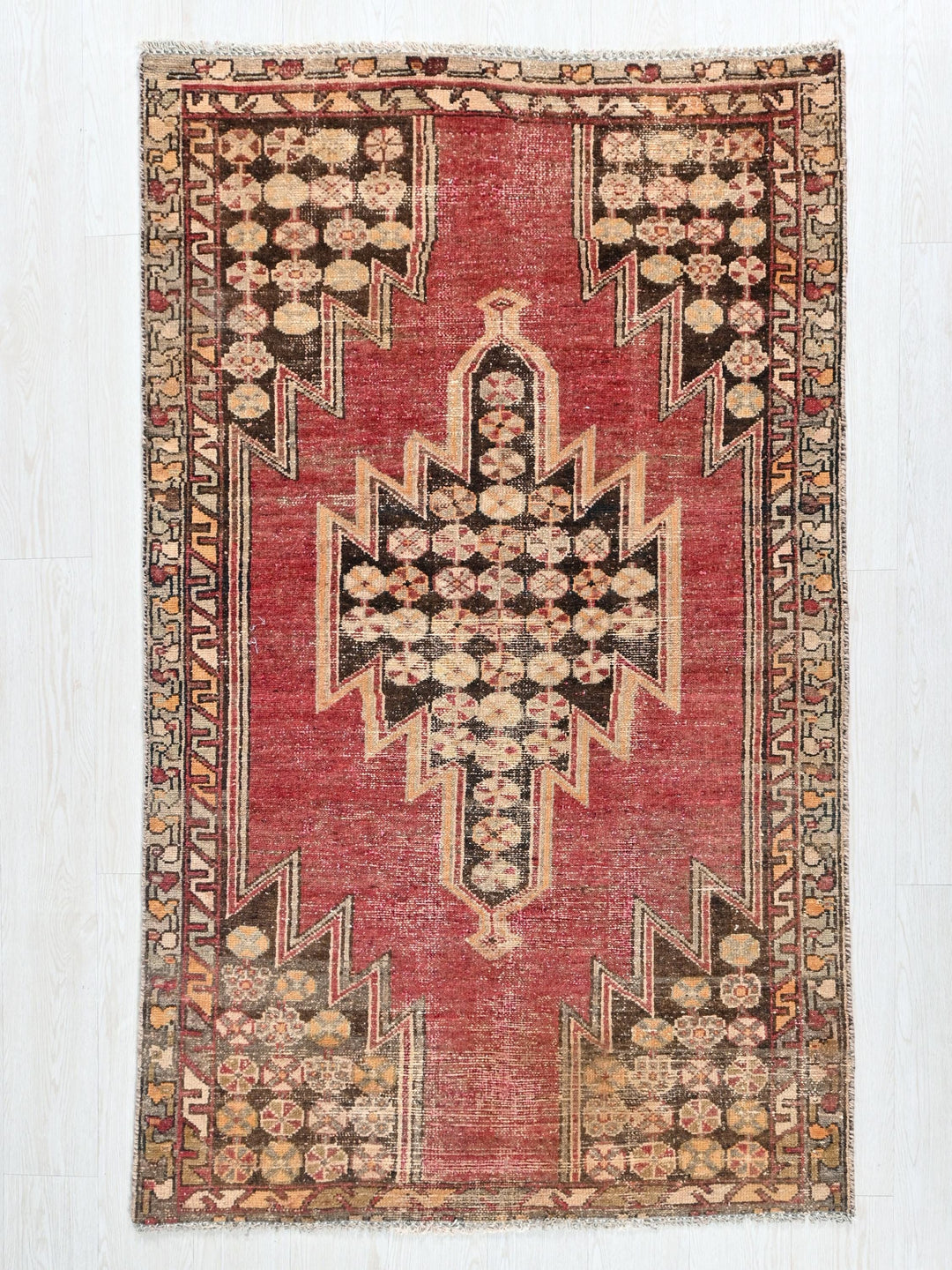 a red rug with an intricate design on it