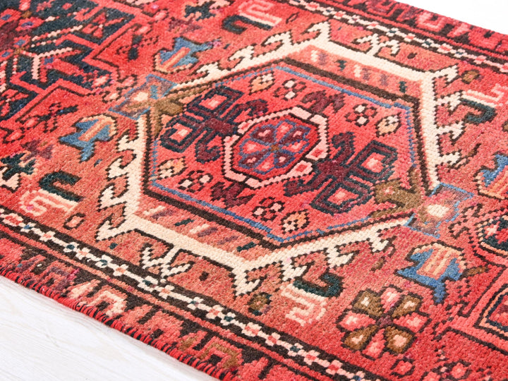 a red rug with an intricate design on it