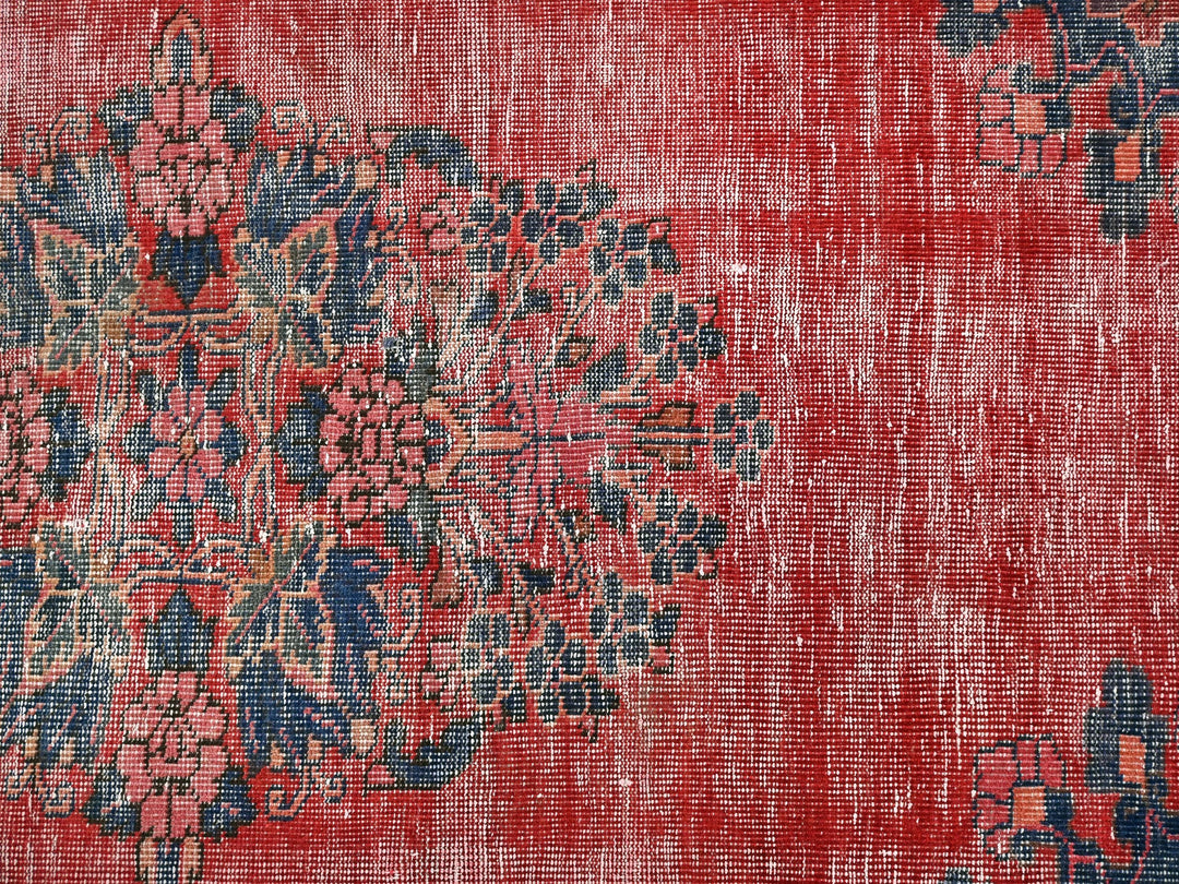 a red rug with a blue and red design on it