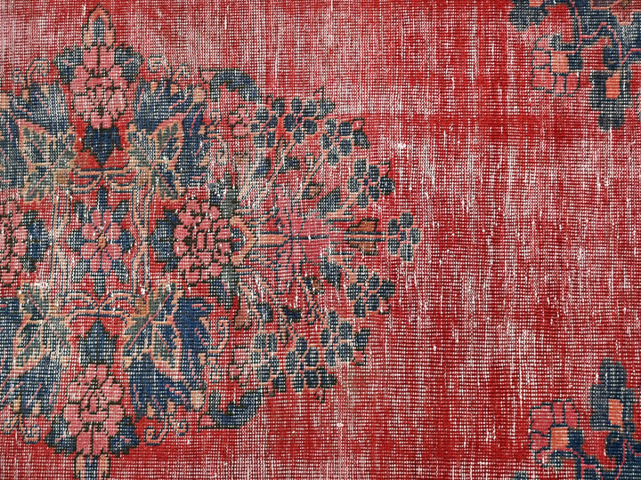 a red rug with a blue and red design on it
