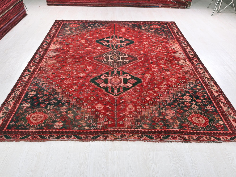a large red rug on a white floor