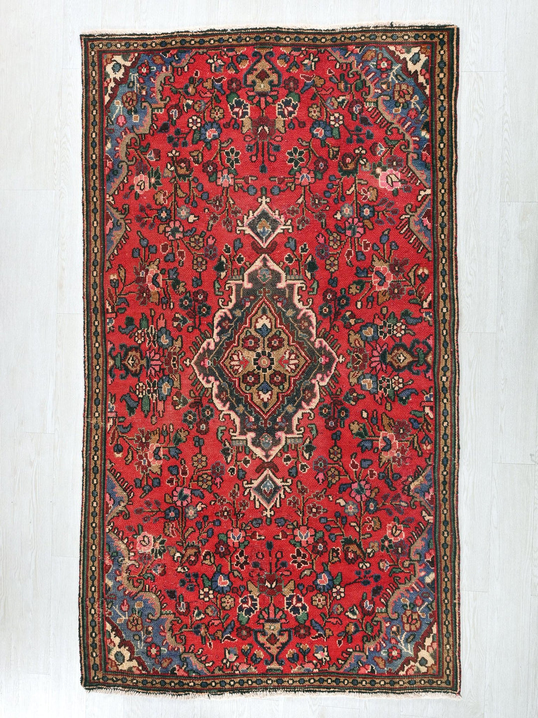 a red rug with a diamond design on it